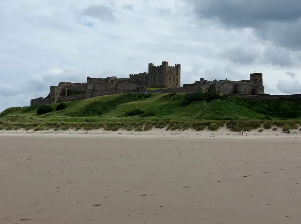 Bamburgh Castle above the dunes and a wide sandy beach