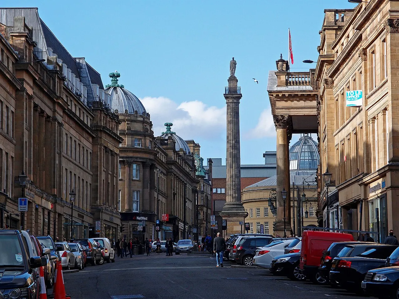 Grey Street's curving stone terraces leading up to Grey's Monument under a blue sky