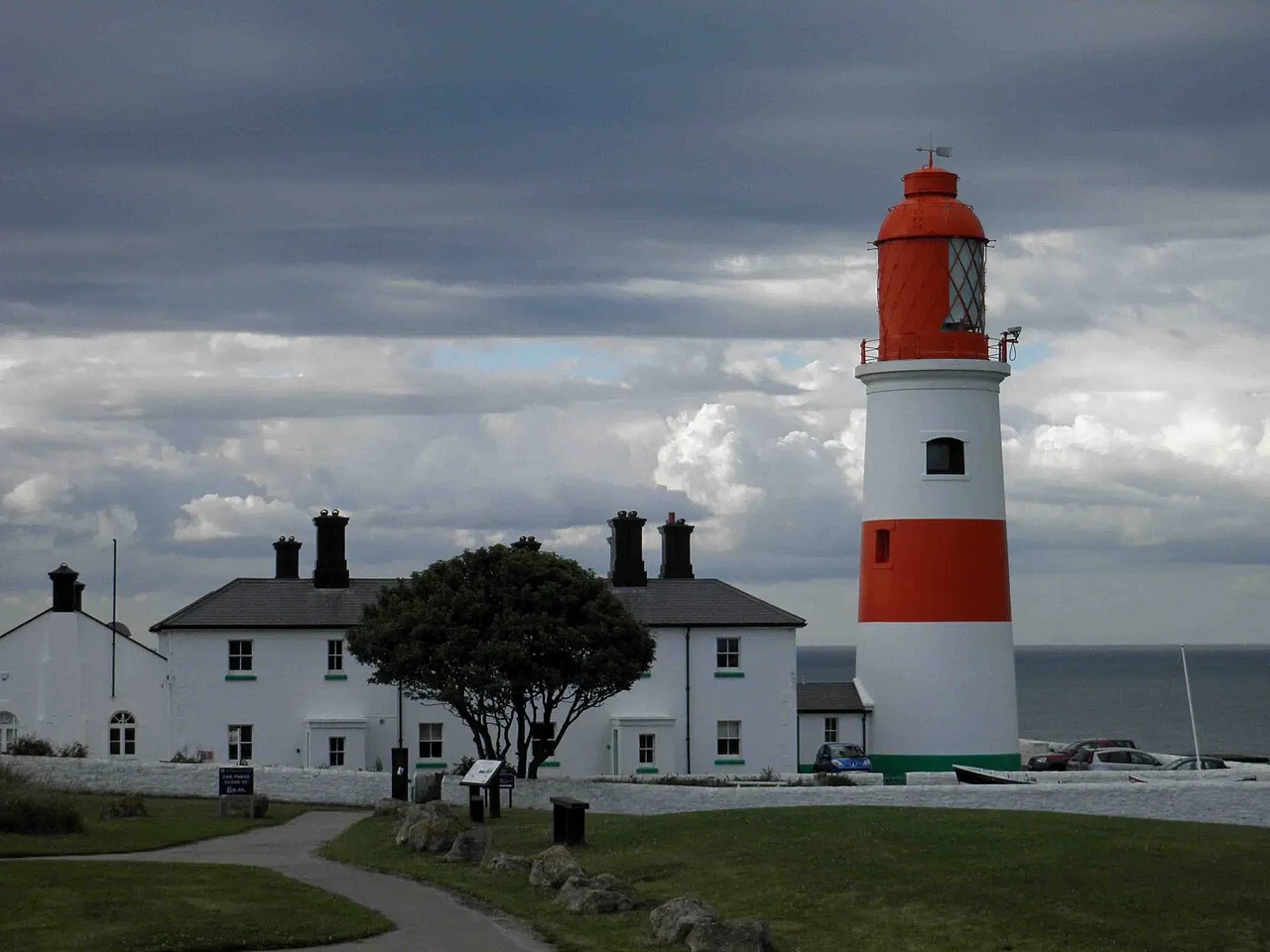 The red and white Souter Lighthouse and its cottages on the clifftop Leas